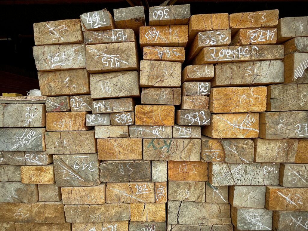 Close-up of numbered wooden planks stacked in a warehouse, showcasing timber storage and organization.